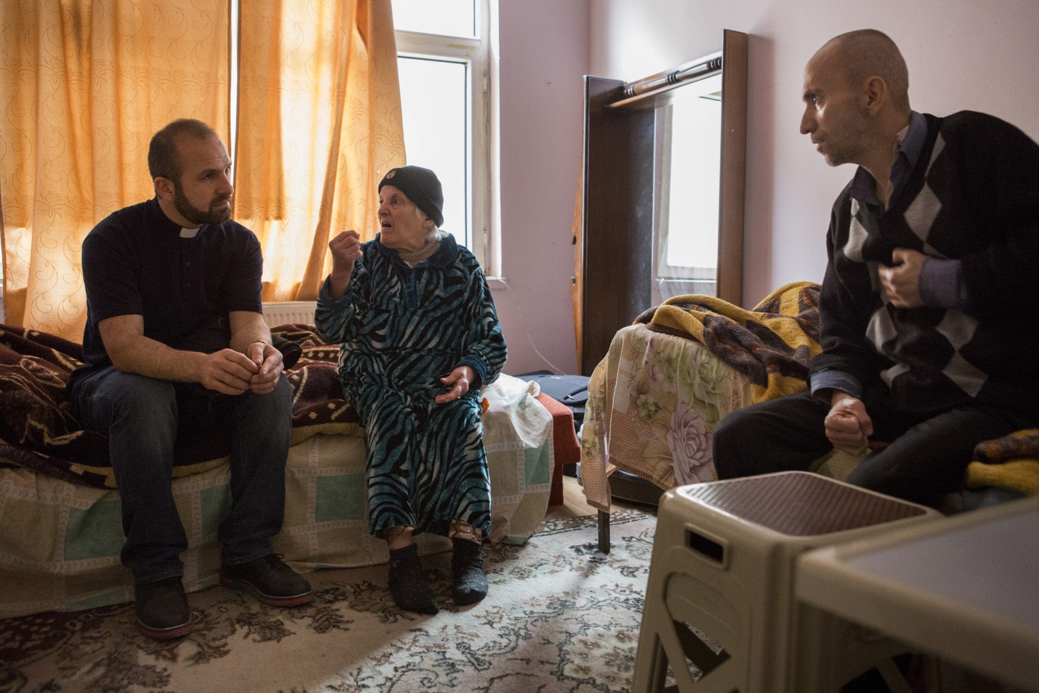 Chaldean Father Remzi Diril, also known as Father Adday, visits an Iraqi Christian refugee family in Kirsehir, Turkey, November 10. (Credit: CNS photo/Oscar Durand.)