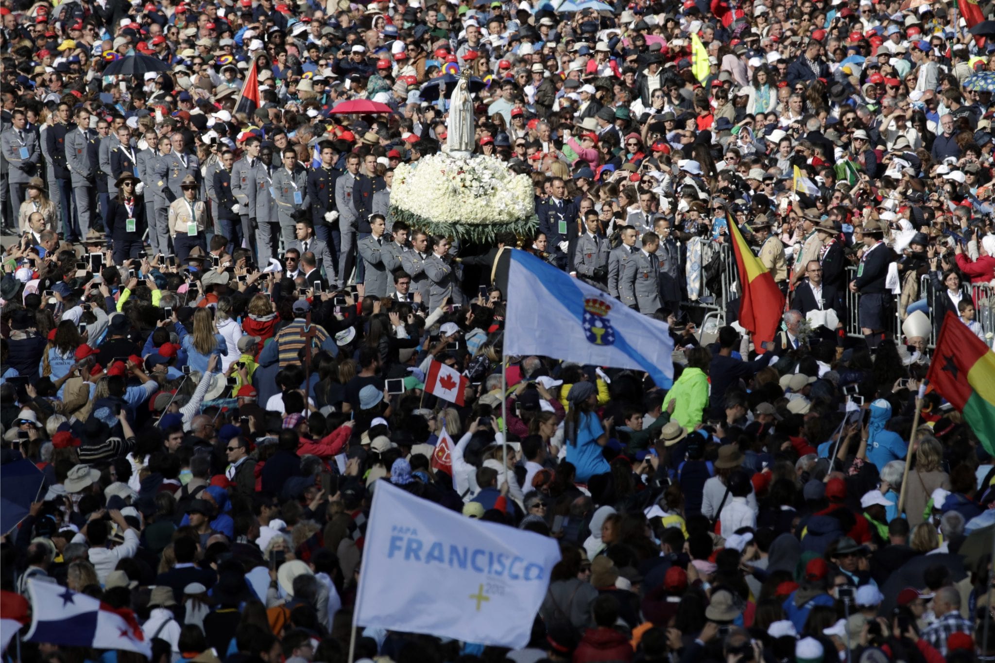 The statue of the Virgin Mary is shoulder carried on procession prior to he start of a mass at the Sanctuary of Our Lady of Fatima Saturday, May 13, 2017, in Fatima, Portugal. Pope Francis will canonize on Saturday two poor, illiterate shepherd children whose visions of the Virgin Mary 100 years ago marked one of the most important events of the 20th-century Catholic Church. (AP Photo/Alessandra Tarantino)